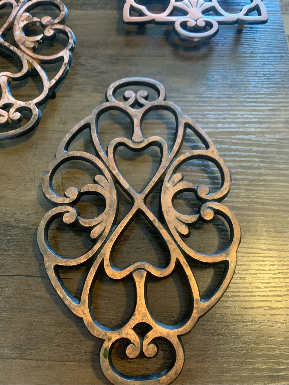 The Pampered Chef Copper-Tone Ornate Trivet Set.